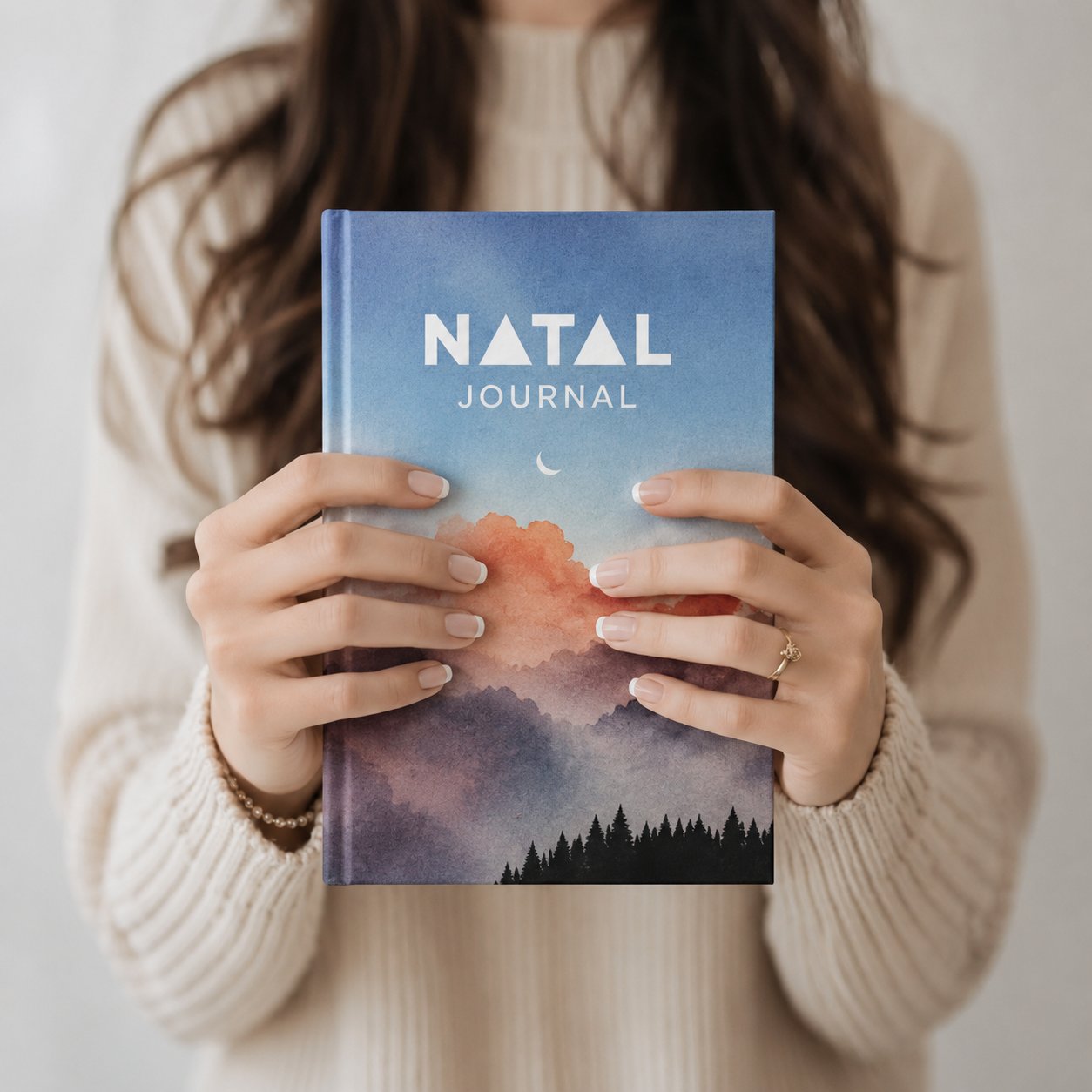 Hands holding a personalized Natal Journal astrology birth chart journal